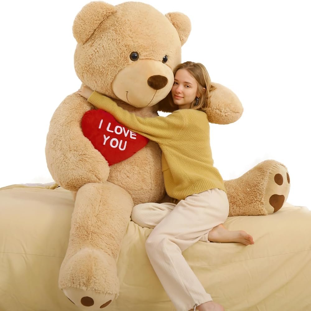 Large cream teddy bear soft toy from Vivantoy surrounded by smaller plush toys